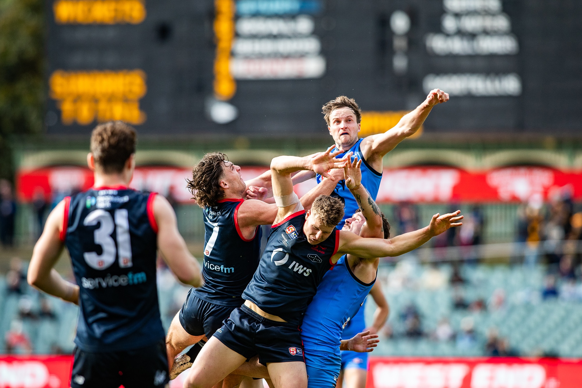 Football players leap for a ball