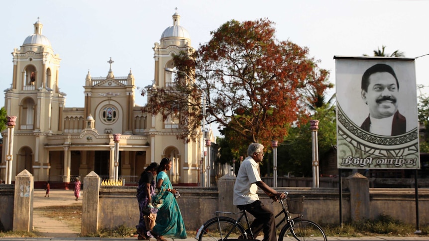 A man cycles past St James Church in Jaffna, northern Sri Lanka