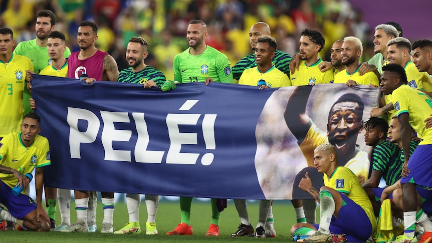 Brazil players hold up a banner reading "Pelé" after their Qatar World Cup match against South Korea in Qatar.