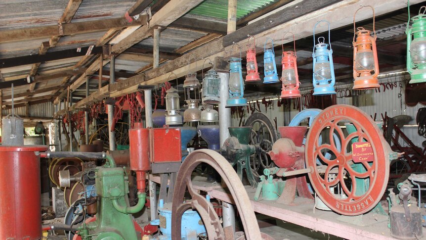 Old, dusty and colourful farming machinery in a shed