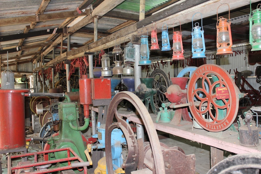 Old, dusty and colourful farming machinery in a shed