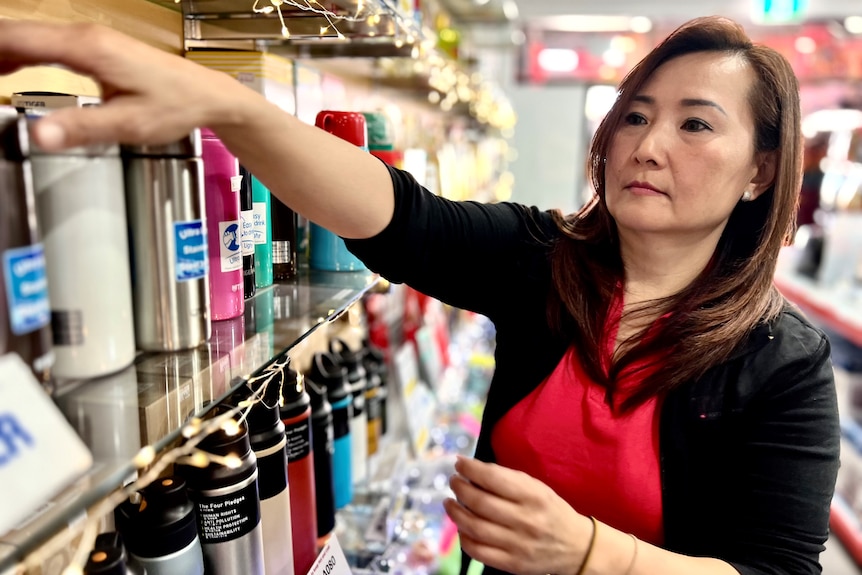 A woman does housekeeping at a homewars store.