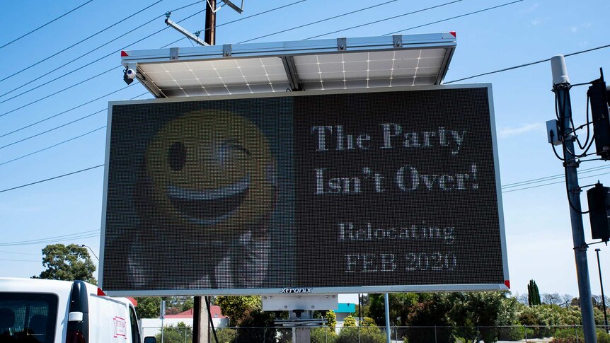 A sign outside a store saying it will be relocated in February and the party isn't over.