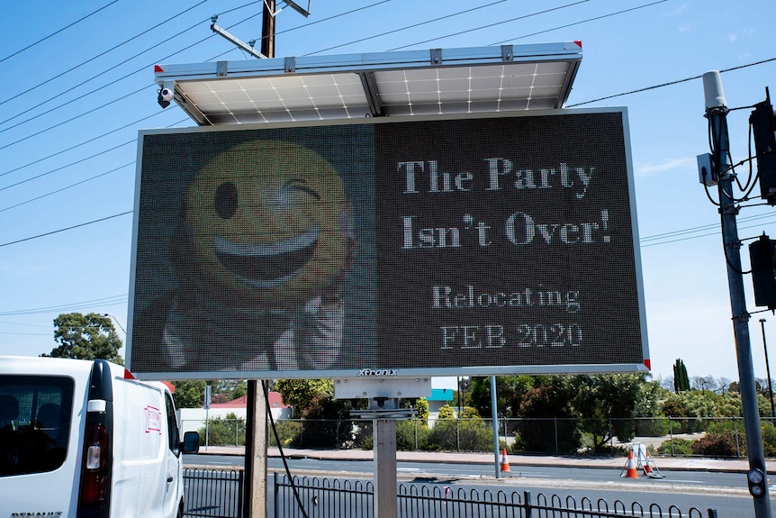 A sign outside a store saying it will be relocated in February and the party isn't over.