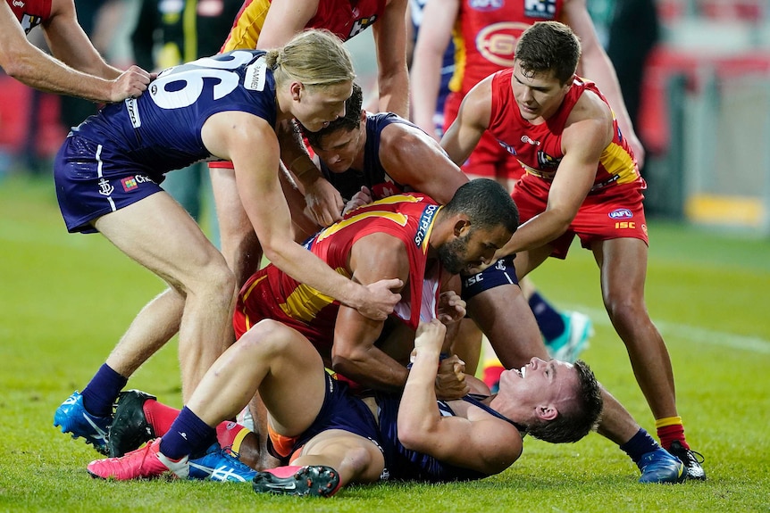 Gold Coast Suns and Fremantle AFL players get involved in a melee.