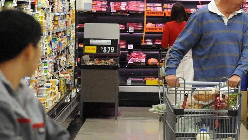 People do their shopping in supermarket aisles