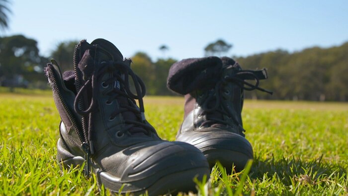 Discarded boots sitting on grass field
