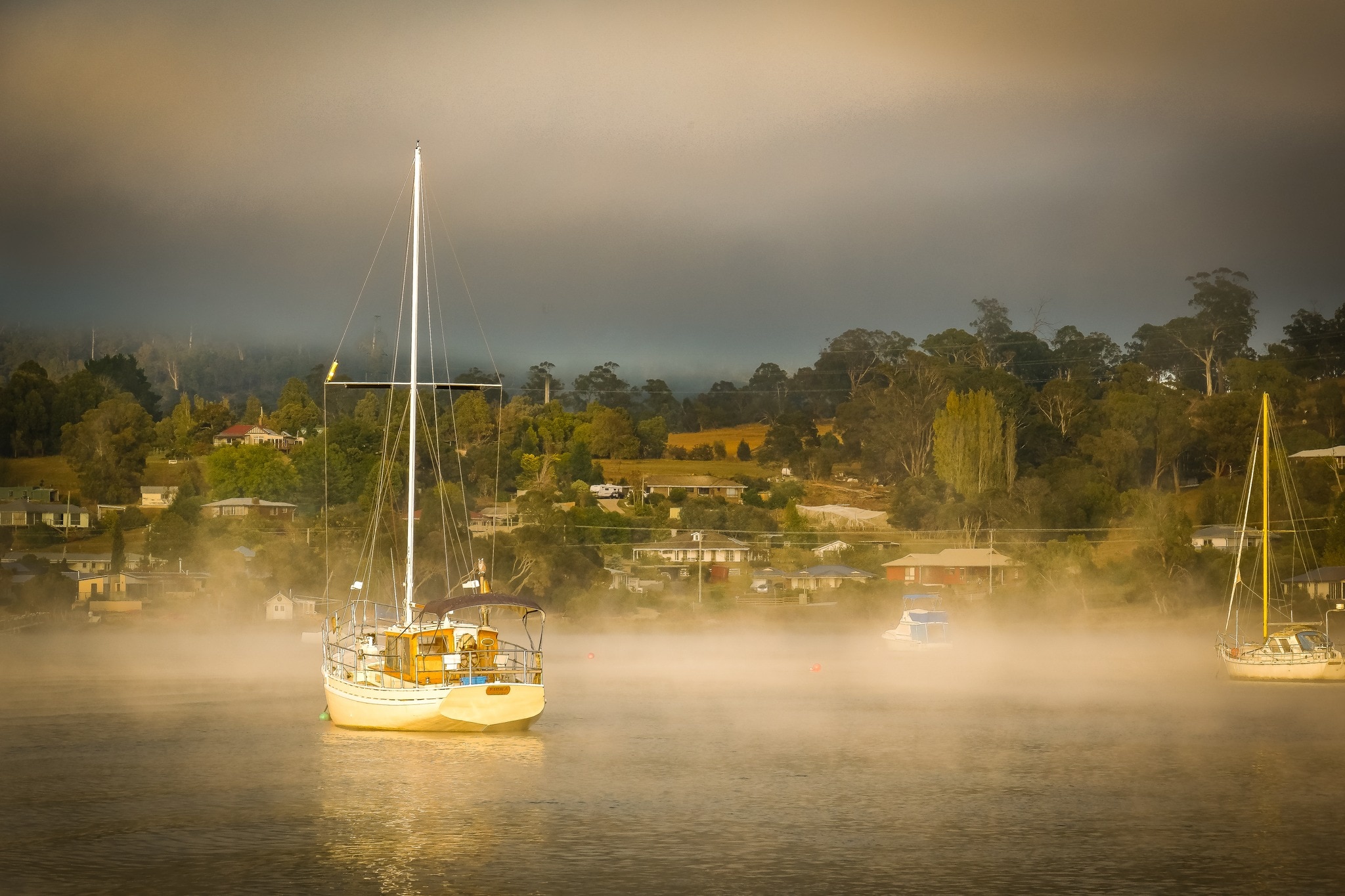 A boat on a river clouded in mist.
