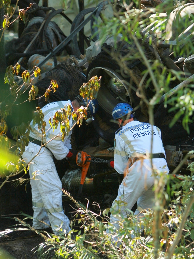 Police rescue officers search a truck with crashed in Kangaroo Valley