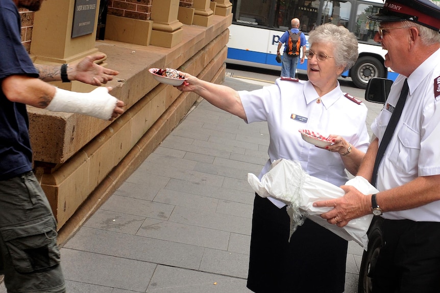 Salvation Army hand out food to a homeless man.