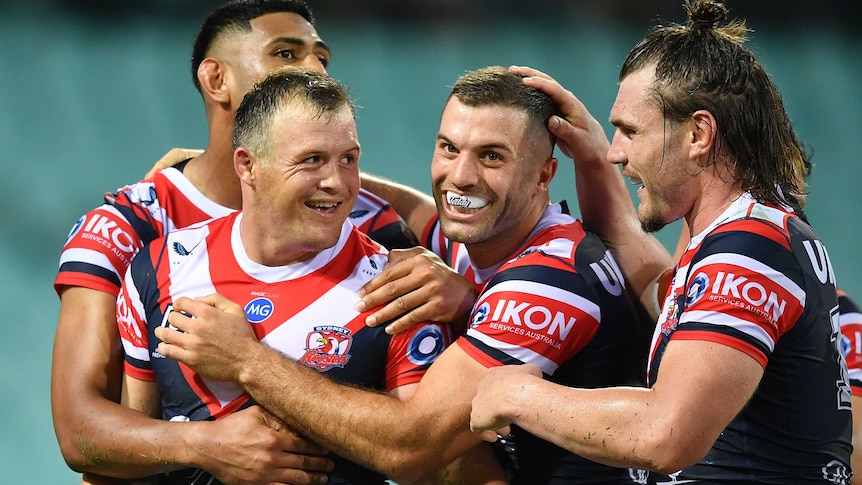 Daniel Tupou, Josh Morris, James Tedesco and Angus Crichton of the Sydney Roosters celebrate a try in their NRL clash with Manly