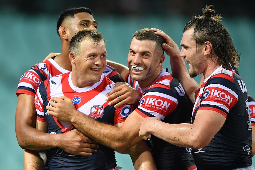 Daniel Tupou, Josh Morris, James Tedesco and Angus Crichton of the Sydney Roosters celebrate a try in their NRL clash with Manly