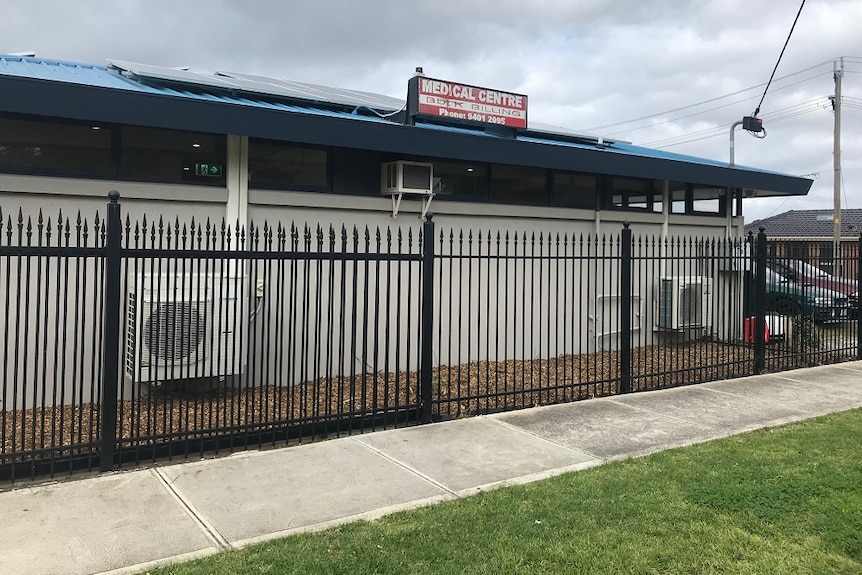 Medical Centre from the outside, white building, which is fenced off