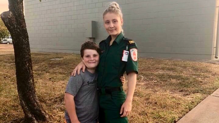 Bianca and Brodie Stubbs stand together on a lawn.