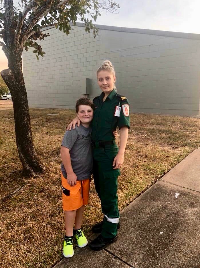 Bianca and Brodie Stubbs stand together on a lawn.