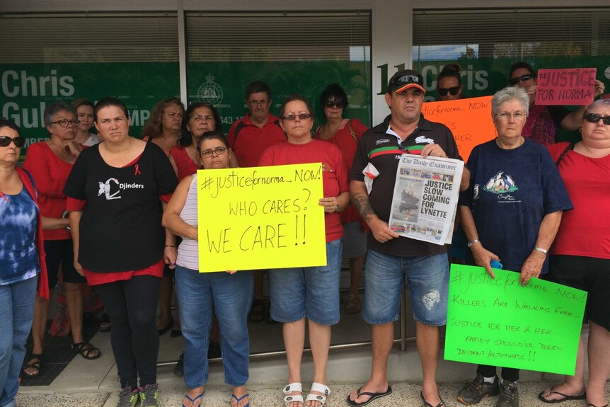 A group of protesters standing outside MP Chris Gulaptis' office in Grafton