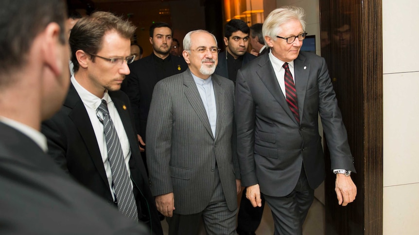 Iran's foreign minister Mohammad Javad Zarif (C) arrives for a meeting in Geneva