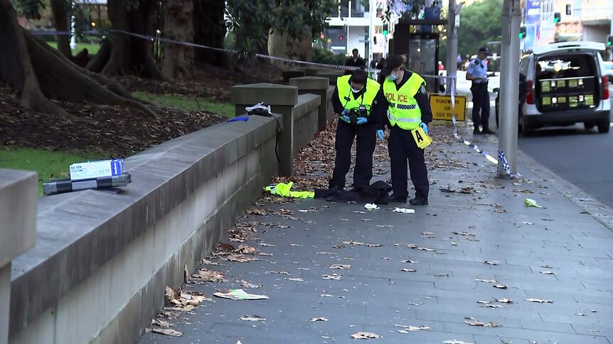 Forensic officers examine and take photos at a Sydney stab scene on 190524