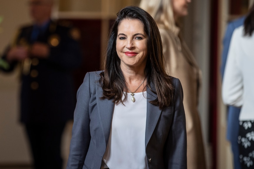 A woman smiling at the camera. 