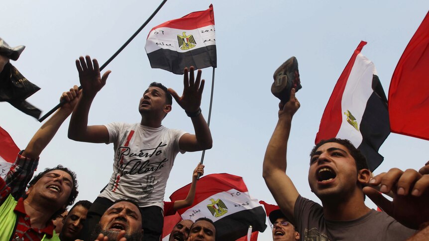 Supporters of Egypt's Muslim Brotherhood candidate Mohammed Mursi wave national flags.