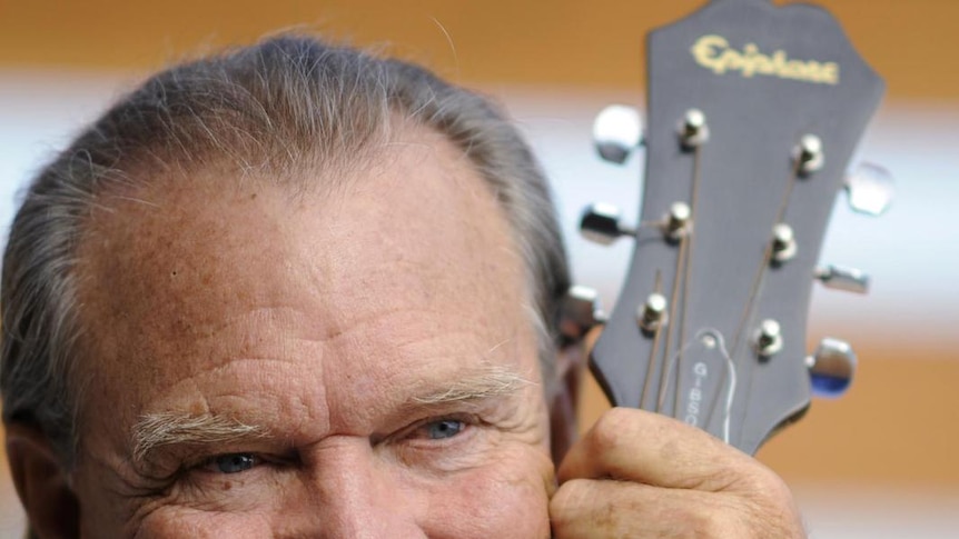 Musician Glen Campbell holds a guitar during a photoshoot at his home in Malibu, California, in August, 2008.