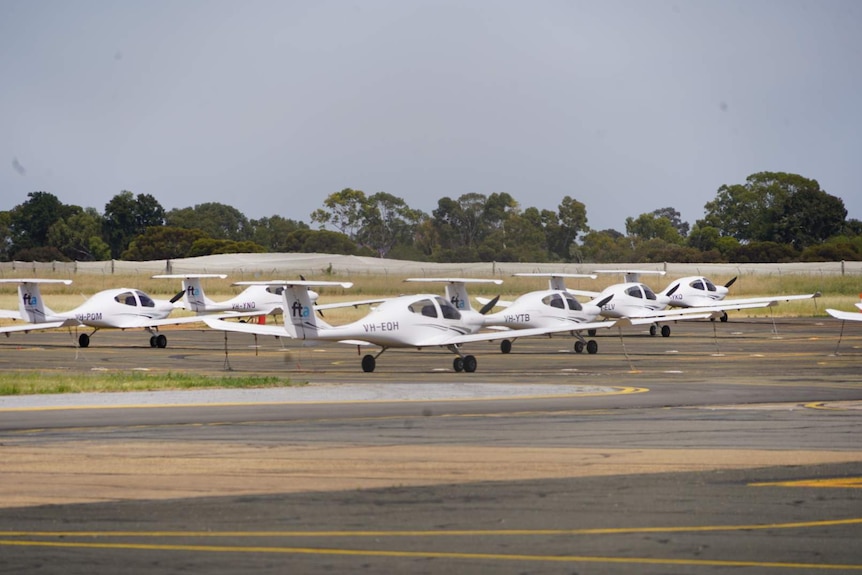 A number of small aircraft parked.