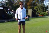 Young croquet player Edward Wilson with mallet in hand.