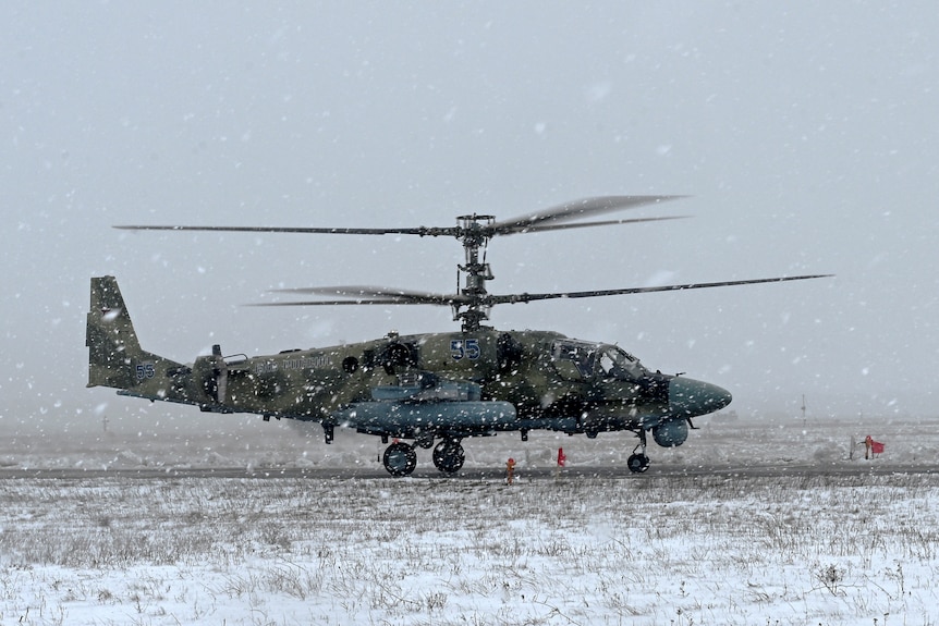 A helicopter in a snowy field 