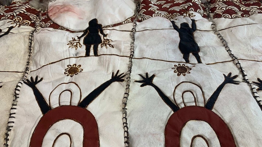 Women figures on possum skin cloak