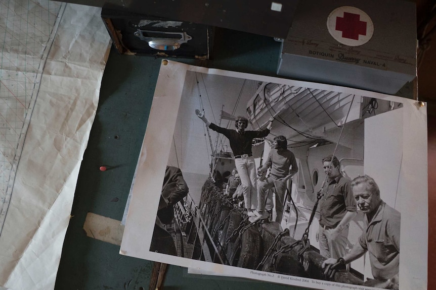 Old photos showing the presenters onboard the ship and a map