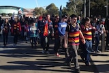 Fans cross the Torrens Footbridge