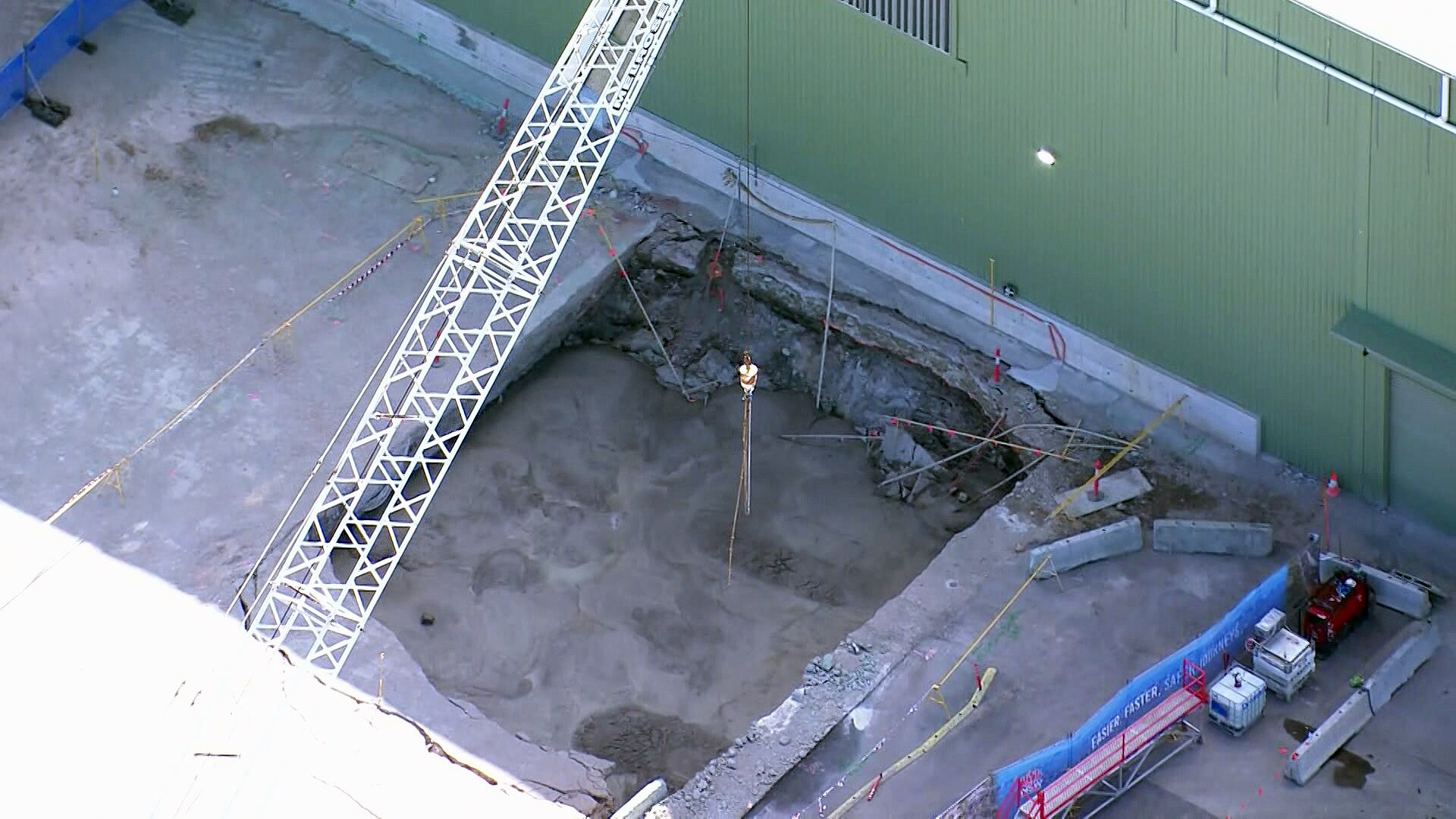 an aerial view of a Rockdale sinkhole full of concrete after it opened on saturday march 9 2024