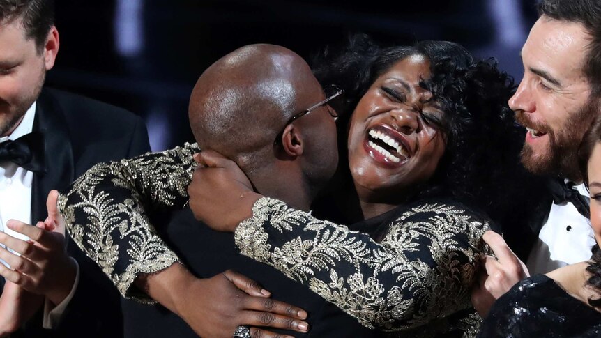 Barry Jenkins hugs Joi McMillon as they celebrate the Best Picture award for Moonlight.