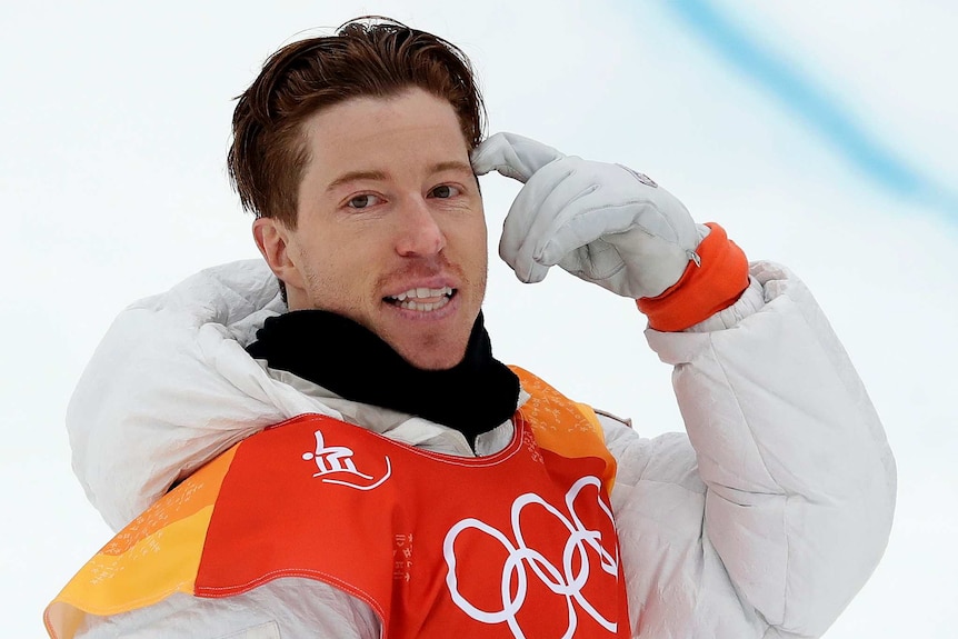 Shaun White points to his head after completing his opening run in the men's snowboard halfpipe final in Pyeongchang.