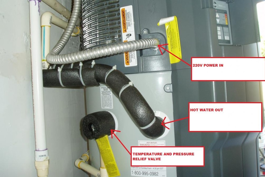 A hot water system with black foam wrapping around the pipes.