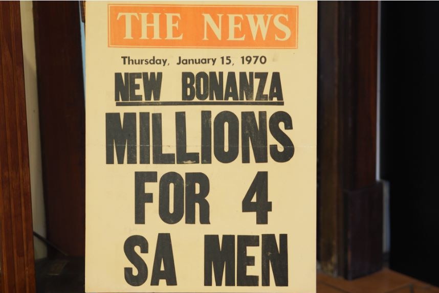 A newspaper headline posted on the news the saying 'Millions for 4 SA men'