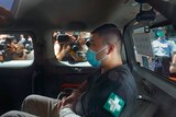 A 23-year-old man, Tong Ying-kit, pictured in a car, arriving at a court in a police van in Hong Kong Monday.