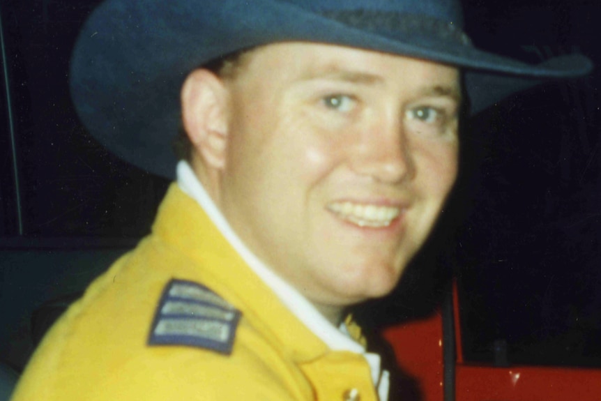 A photograph of Shane Fitzsimmons, smiling, wearing a wide-brim hat