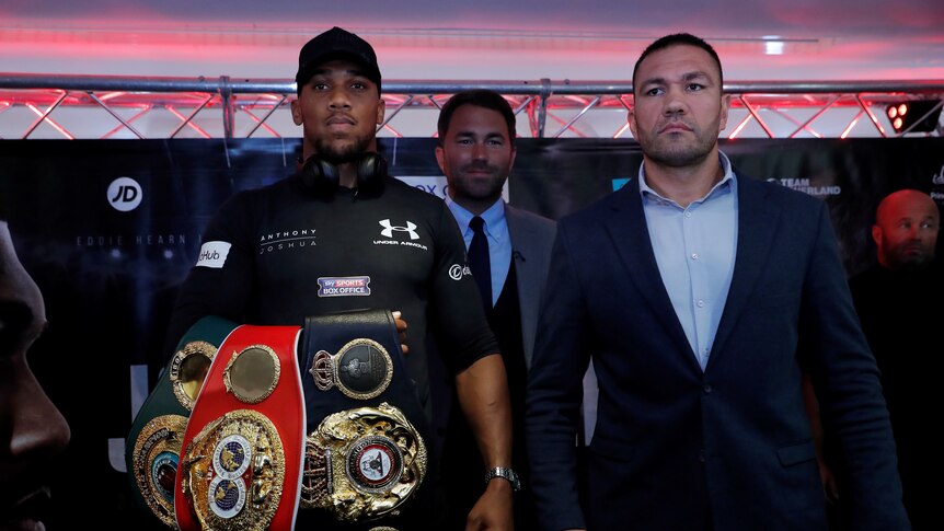 Kubrat Pulev stands next to Anthony Joshua during a press conference