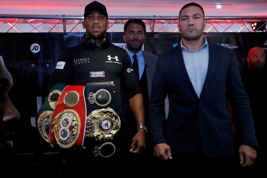 Kubrat Pulev stands next to Anthony Joshua during a press conference