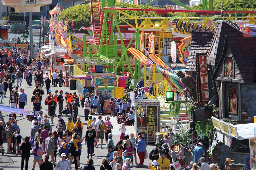 Crowds walk along sideshow alley on opening day of the Ekka in 2013.