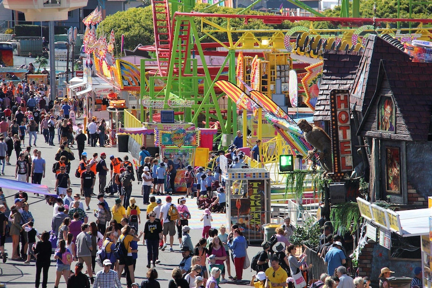 Crowds walk along sideshow alley