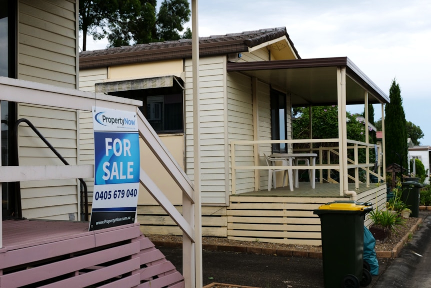 House with a for sale sign