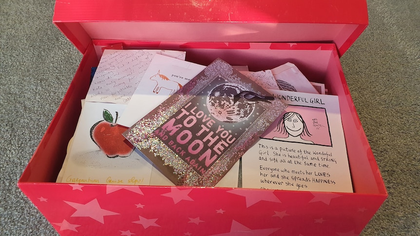 A box containing hand written letters and cards.