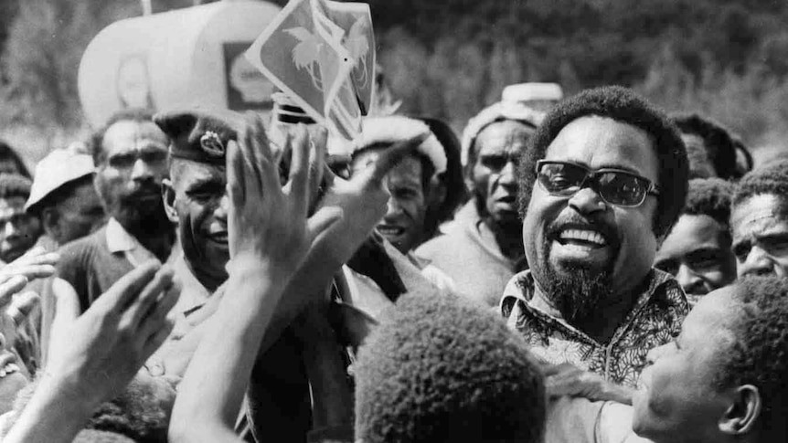 Chief minister Michael Somare handing out flags in 1974