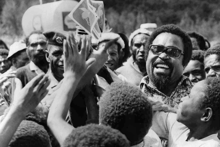 Chief minister Michael Somare handing out flags in 1974