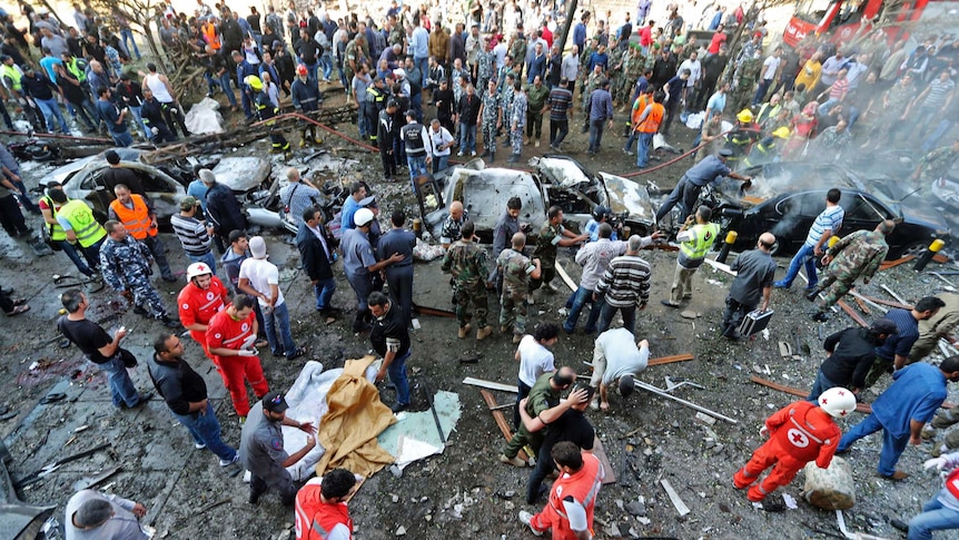 Emergency personnel gather at the site of explosions near the Iranian embassy in Beirut