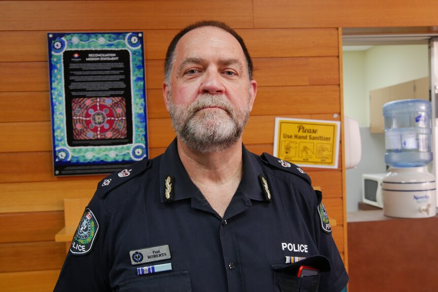 An older man with a salt-and-pepper beard wearing a police uniform.