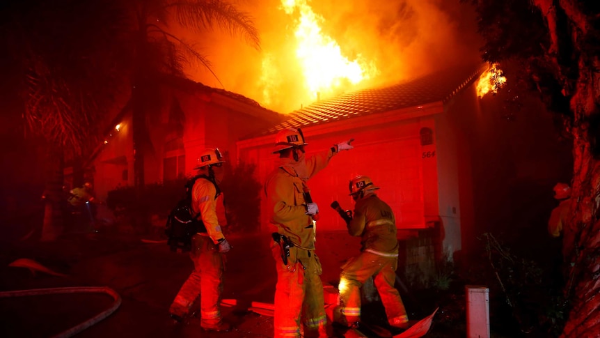 Firefighters battle flames at a home in Thousand Oaks.