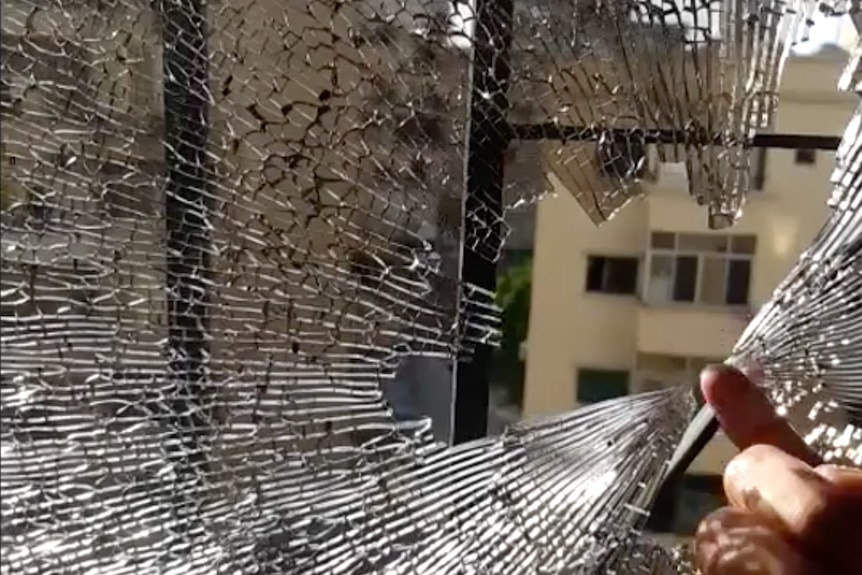 A window pane is shown shattered following the violence on Beirut's streets.